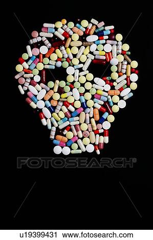 Stock Image - Pills and tablets in the shape of a skull. Fotosearch