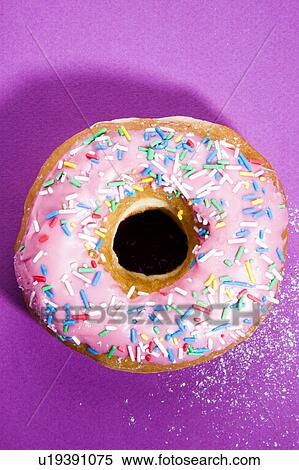 Pink doughnut with sprinkles View Large Photo Image Stock Photography - Pink doughnut with sprinkles. Fotosearch