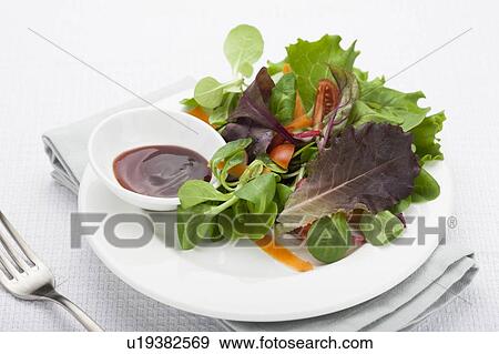 Stock Photo - Plate of salad and sauce. Fotosearch