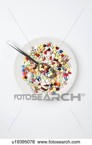 Stock Photo - Plate with pills and spoon. Fotosearch