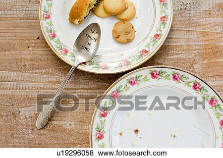 Plates of cookies and spoon engraved with slogan on wooden surface View Large Photo Image Stock Photo - Plates of cookies and spoon engraved with slogan on wooden surface. Fotosearch