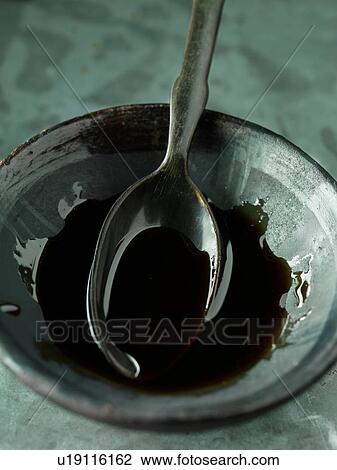 Pomegranate molasses in bowl with spoon, close-up View Large Photo Image Stock Image - Pomegranate molasses in bowl with spoon, close-up. Fotosearch