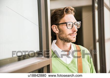 Portrait of cool businessman gazing from office doorway View Large Photo Image Stock Image - Portrait of cool businessman gazing from office doorway. Fotosearch