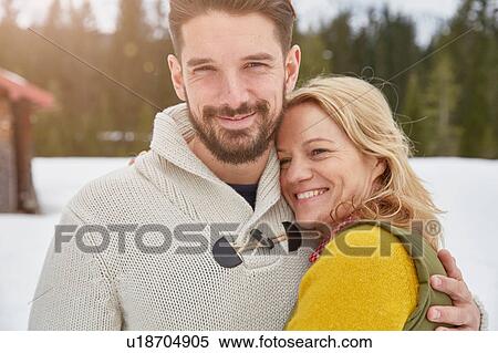 Stock Photography - Portrait of couple in snow, Elmau, Bavaria, Germany. Fotosearch