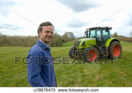 Portrait of farmer in field in front of tractor View Large Photo Image Stock Photography - Portrait of farmer in field in front of tractor. Fotosearch
