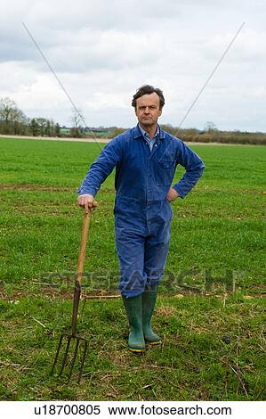 Portrait of farmer leaning on pitch fork in field View Large Photo Image Stock Photography - Portrait of farmer leaning on pitch fork in field. Fotosearch