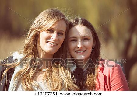 Portrait of female friends looking at camera smiling View Large Photo Image Stock Image - Portrait of female friends looking at camera smiling. Fotosearch