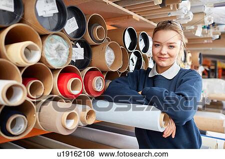 Portrait of female worker with fabric rolls in roller blind factory View Large Photo Image Stock Photo - Portrait of female worker with fabric rolls in roller blind factory. Fotosearch