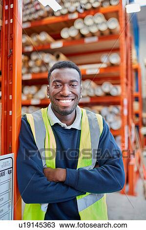 Stock Image - Portrait of male factory worker in factory warehouse. Fotosearch