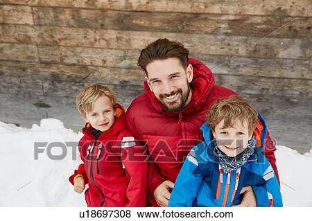 Portrait of man and sons at cabin in snow, Elmau, Bavaria, Germany View Large Photo Image Stock Photo - Portrait of man and sons at cabin in snow, Elmau, Bavaria, Germany. Fotosearch