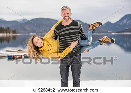 Portrait of man carrying woman on side, German Alps, Germany View Large Photo Image Stock Image - Portrait of man carrying woman on side, German Alps, Germany. Fotosearch