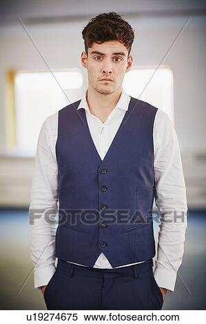 Portrait of man wearing waist coat, hands in pockets looking at camera View Large Photo Image Stock Photography - Portrait of man wearing waist coat, hands in pockets looking at camera. Fotosearch