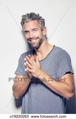 Portrait of mid adult man, hands together, smiling View Large Photo Image Stock Image - Portrait of mid adult man, hands together, smiling. Fotosearch