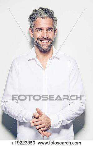 Portrait of mid adult man, hands together, smiling View Large Photo Image Stock Image - Portrait of mid adult man, hands together, smiling. Fotosearch