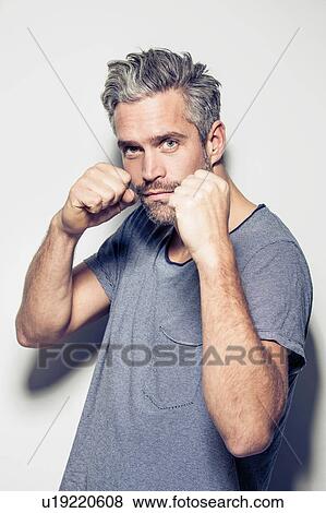 Portrait of mid adult man in boxing pose View Large Photo Image Stock Photo - Portrait of mid adult man in boxing pose. Fotosearch
