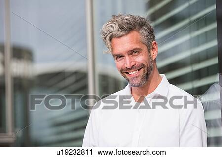Portrait of mid adult man, outdoors, smiling View Large Photo Image Stock Image - Portrait of mid adult man, outdoors, smiling. Fotosearch