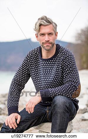 Stock Photo - Portrait of mid adult man, outdoors, German Alps, Germany. Fotosearch