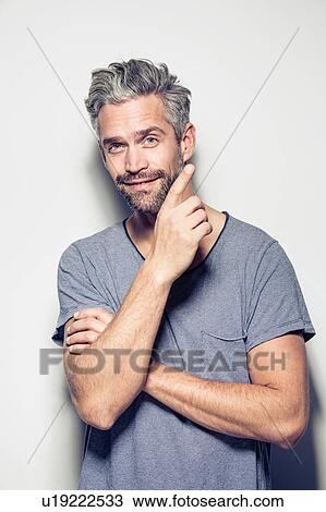 Portrait of mid adult man, touching face, smiling View Large Photo Image Stock Image - Portrait of mid adult man, touching face, smiling. Fotosearch