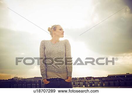 Portrait of mid adult woman with hands in pockets on rooftop parking lot View Large Photo Image Stock Photo - Portrait of mid adult woman with hands in pockets on rooftop parking lot. Fotosearch