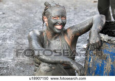 Stock Image - Portrait of woman covered in therapeutic mud, Dead Sea, Israel. Fotosearch