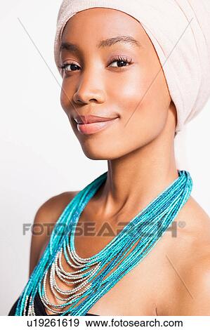Stock Photo - Portrait of woman wearing headscarf and statement necklace. Fotosearch