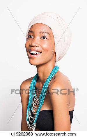 Stock Photo - Portrait of woman wearing headscarf and statement necklace. Fotosearch