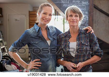 Stock Photo - Portrait of women side by side looking at camera smiling. Fotosearch