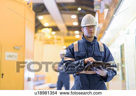 Picture - Portrait of worker in generating hall in hydroelectric power station. Fotosearch