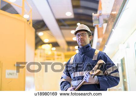 Portrait of worker in generating hall in hydroelectric power station View Large Photo Image Stock Photo - Portrait of worker in generating hall in hydroelectric power station. Fotosearch