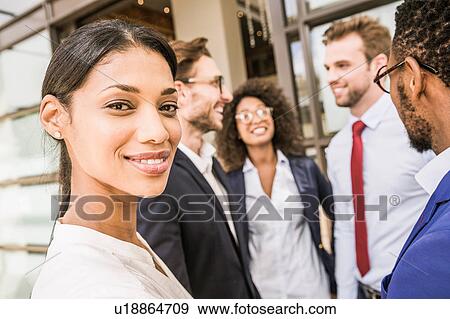 Portrait of young businesswoman and team outside office View Large Photo Image Stock Photo - Portrait of young businesswoman and team outside office. Fotosearch