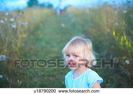 Portrait of young girl in field View Large Photo Image Stock Image - Portrait of young girl in field. Fotosearch