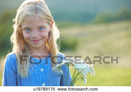 Stock Photography - Portrait of young girl in field. Fotosearch