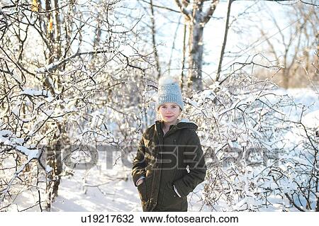 Stock Image - Portrait of young girl in snowy landscape. Fotosearch