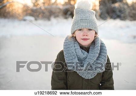 Stock Image - Portrait of young girl in snowy landscape. Fotosearch