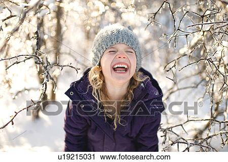 Portrait of young girl laughing, in snowy landscape View Large Photo Image Stock Image - Portrait of young girl laughing, in snowy landscape. Fotosearch