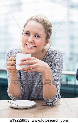 Portrait of young woman drinking coffee, milk moustache on upper lip, smiling View Large Photo Image Stock Photo - Portrait of young woman drinking coffee, milk moustache on upper lip, smiling. Fotosearch