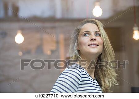 Portrait of young woman, looking away, smiling View Large Photo Image Stock Image - Portrait of young woman, looking away, smiling. Fotosearch