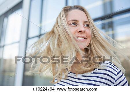 Portrait of young woman outdoors, smiling View Large Photo Image Picture - Portrait of young woman outdoors, smiling. Fotosearch
