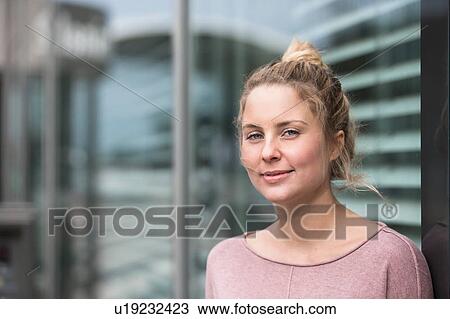 Portrait of young woman, outdoors, smiling View Large Photo Image Stock Image - Portrait of young woman, outdoors, smiling. Fotosearch