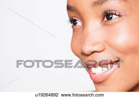 Portrait of young woman, smiling, close-up View Large Photo Image Stock Image - Portrait of young woman, smiling, close-up. Fotosearch