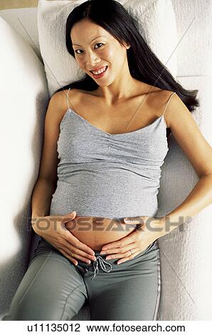 Stock Image - Pregnant woman at eight months. Fotosearch