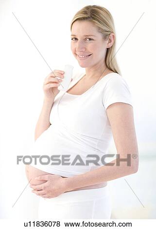 Stock Photo - Pregnant woman drinking milk. Fotosearch