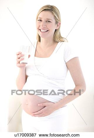 Pregnant woman drinking milk View Large Photo Image Stock Photo - Pregnant woman drinking milk. Fotosearch