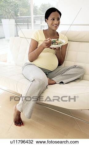 Pregnant woman eating a salad View Large Photo Image Stock Image - Pregnant woman eating a salad. Fotosearch