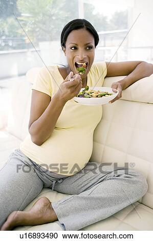 Pregnant woman eating a salad View Large Photo Image Stock Image - Pregnant woman eating a salad. Fotosearch