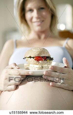 Pregnant woman eating View Large Photo Image Picture - Pregnant woman eating. Fotosearch