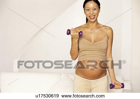 Stock Photo - Pregnant woman exercising. Fotosearch