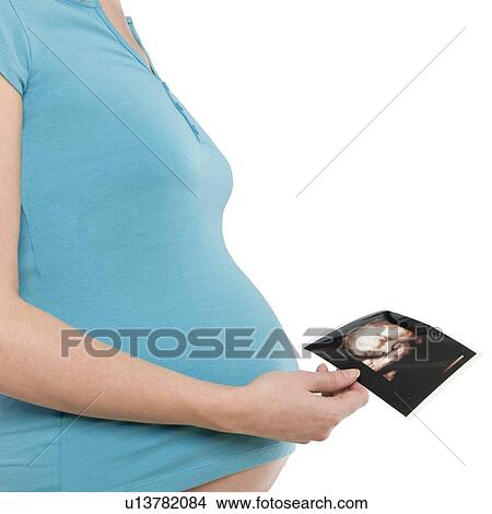 Pregnant woman holding her baby scan View Large Photo Image Picture - Pregnant woman holding her baby scan. Fotosearch