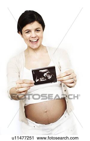 Pregnant woman holding her baby scan View Large Photo Image Stock Image - Pregnant woman holding her baby scan. Fotosearch