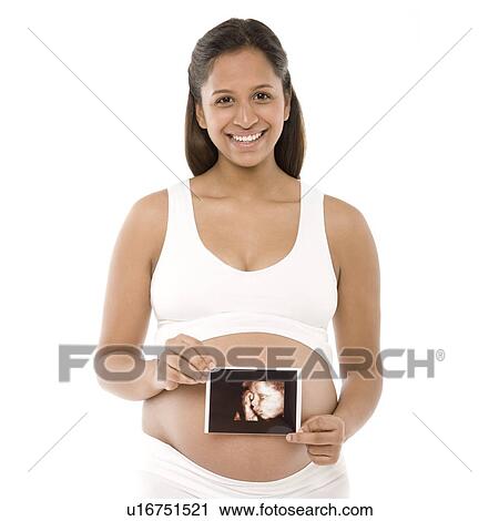 Pregnant woman holding her baby scan View Large Photo Image Stock Image - Pregnant woman holding her baby scan. Fotosearch